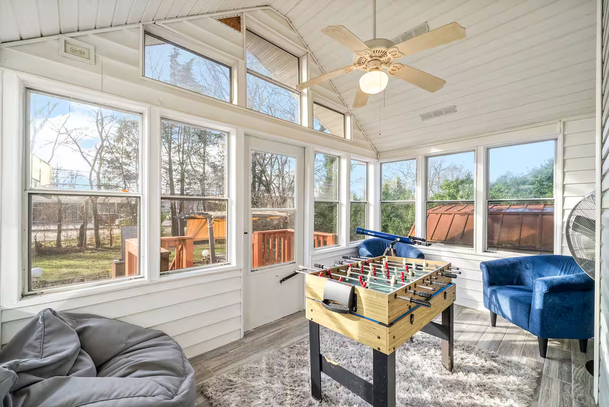 Bright furnished sunroom with seating in a home